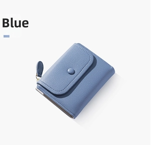 Close-up of light blue pebble grain leather wallet with snap button and metal zipper