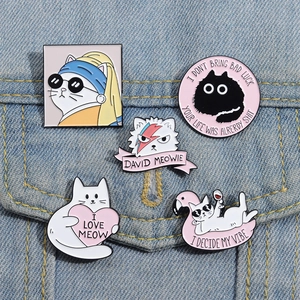 Creative white cat enamel pins set on denim jacket, featuring artistic pearl earring cat