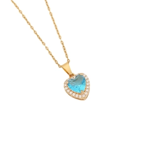 Gold heart pendant necklace with blue center stone and zircon border on white background