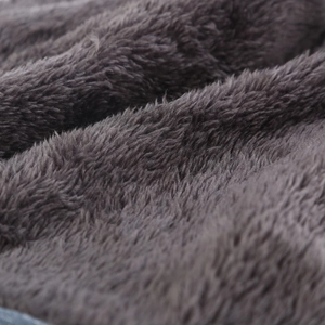 Macro shot of fluffy dark grey faux fur fabric texture showing soft material details