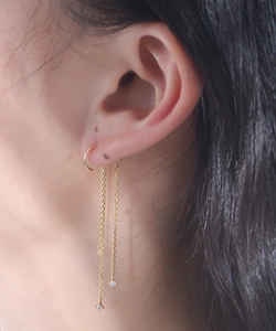Close-up of elegant gold chain tassel earrings with star-shaped zircons worn by model