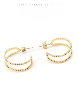 Detail view of 18K gold plated double-layer beaded hoop earrings on white background