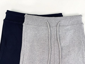 Detail view of high waist yoga shorts featuring elastic waistband and drawstring cords