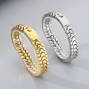 Detailed close-up of polished gold and silver stainless steel dragon bone chain bracelets