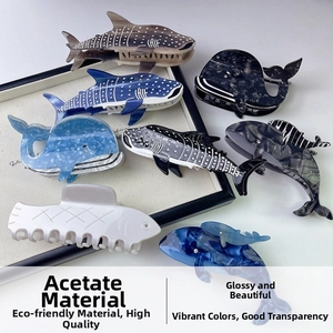 Detailed view of ocean-themed acetic acid hair clips in whale and tropical fish shapes