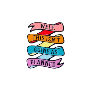Rainbow ribbon enamel pin with 'WELP. THIS ISN'T GOING AS PLANNED.' inspirational quote