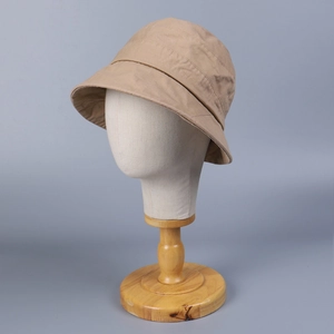 Close-up of khaki cotton bucket hat stitching details on mannequin display