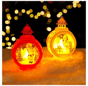 Close-up of LED Christmas lanterns with Santa and snowman motifs on a snowy background