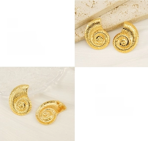 Detailed macro view of 18K gold plated conch spiral earrings with high polish finish