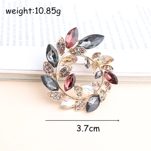 Macro view of crystal wreath brooch with size 3.7cm and weight 10.85g on book background
