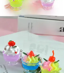 Detailed view of colorful miniature fruit sundae cup pendants with resin cream and metal hooks