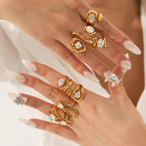 Golden titanium steel geometric rings set with clear zircon on model's hand