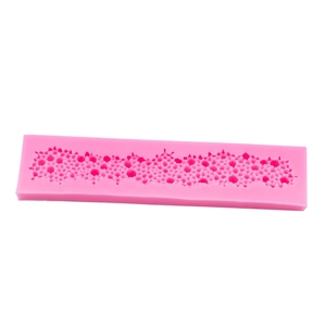 Pink silicone fondant mold with detailed floral and lace patterns for cake borders