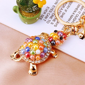 Charming turtle keychain with colorful beads and crystals on a golden metal ring