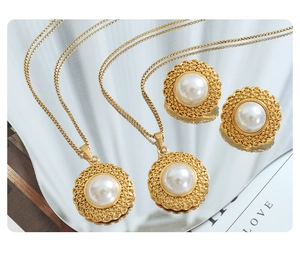 Detail view of retro hat-shaped jewelry set with white pearls and hollow pattern gold finish