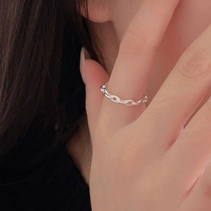 Detail of 925 sterling silver chain ring worn on finger in a minimalist style