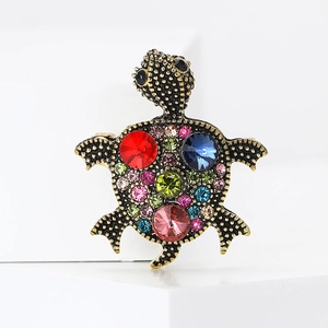 Vintage gold turtle brooch featuring colorful rhinestones and intricate crystal accents