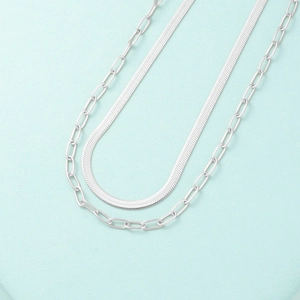 Detail of silver double-layered necklace showing flat snake chain and paperclip links
