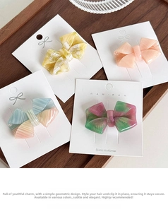 Detailed macro view of acetate bow hair clips in pastel colors on wooden tray