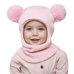 Detailed knit texture of pink baby balaclava with dual fluffy pom-poms and ear flaps