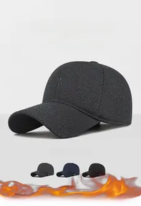 Detail view of winter earflap baseball cap with H embroidery and thick thermal fabric