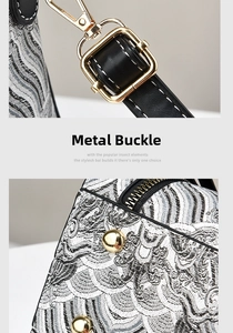 Detailed macro view of golden metal buckles and fine cloud embroidery on a crossbody handbag