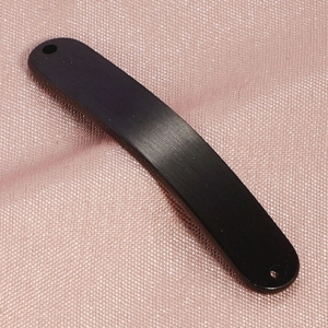Close-up of black brushed curved titanium steel bar connector for DIY jewelry making