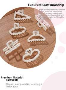 Detail of six French style hair claws with elegant faux pearls on a rustic wood background