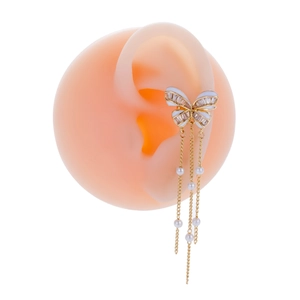 Detail of gold butterfly ear cuff with long pearl chain tassels on a silicone model