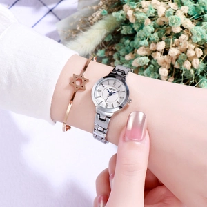 Close-up of elegant silver women's watch with rose gold hexagram star bracelet detail