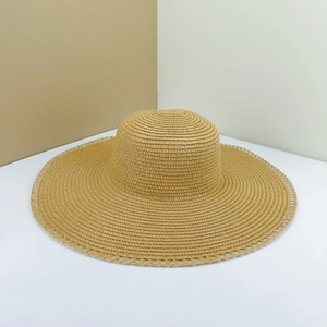 Women's foldable straw sun hat with wide lace-edge brim in natural beige color