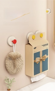 Detail of vacuum suction wall hook holding a towel box in a modern bathroom setup