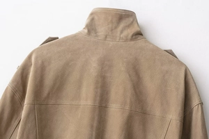 Detail view of the khakhi faux suede jacket showing neck stitching and soft fabric texture