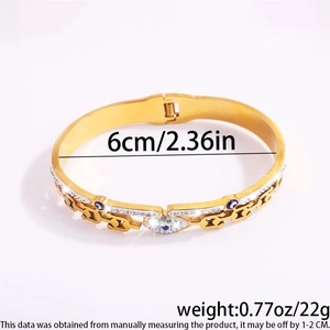 Detail view of gold Evil Eye bangle with dimensions 6cm and weight 22g on white backdrop