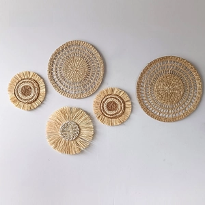 Detailed set of five woven seagrass wall plates with fringe in Bohemian style