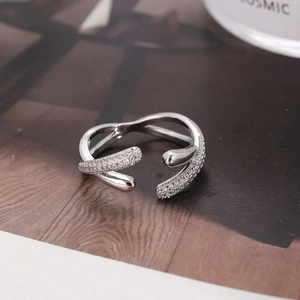 Luxury silver wavy open ring with micro-pave cubic zirconia on wood background