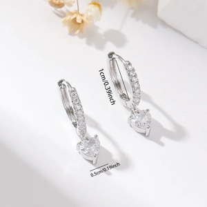Detail showing 1cm silver hoop earring with 0.5cm zircon heart pendant on white background