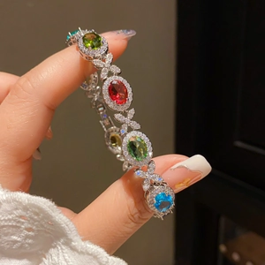 Detailed close-up of a French court style bracelet with colorful gems and white diamonds