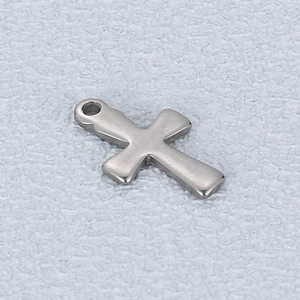 Detailed view of a silver stainless steel cross pendant with a smooth polished finish