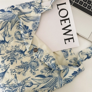 Detail view of vintage blue floral cotton tote with magnetic buckle and fabric texture