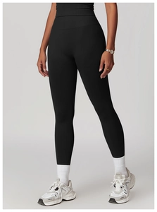 Full body view of high waist black yoga leggings and matching vest with athletic shoes