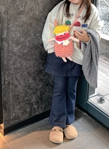 Handmade crochet doll shoulder bag for kids paired with casual pink sweatshirt and blue pants