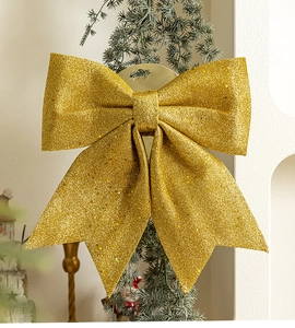 Close-up of golden glitter Christmas bow with shimmering sequins for festive tree decoration