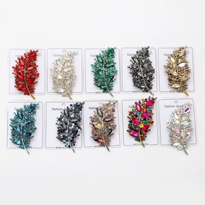 Detailed grid of leaf-shaped brooches set with sparkling rhinestones in ten vibrant colors
