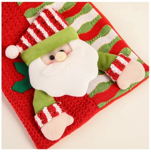 Detailed view of knitted Christmas gift bag featuring 3D Santa Claus doll and soft texture