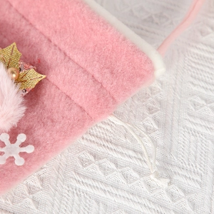 Pink plush Christmas gift bag with white faux fur trim, snowflake and holly sequin detail