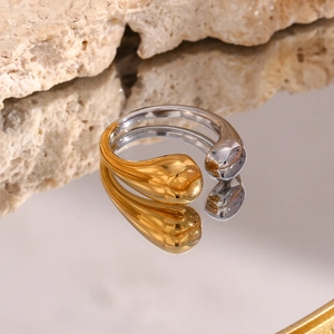 Detailed macro view of two-tone open teardrop ring with polished gold and silver finish