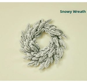 Detail of lush green artificial pine wreath with realistic white snow flocking effect
