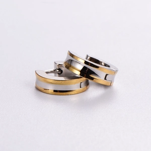 Minimalist stainless steel hoop earrings with a grooved two-tone gold and silver design
