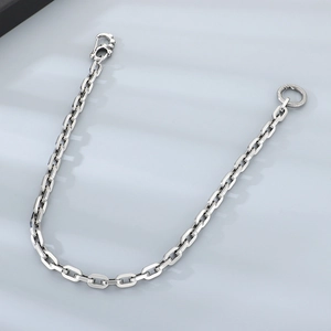 Detail of punk style skull link chain with lobster clasp and textured O-ring closure